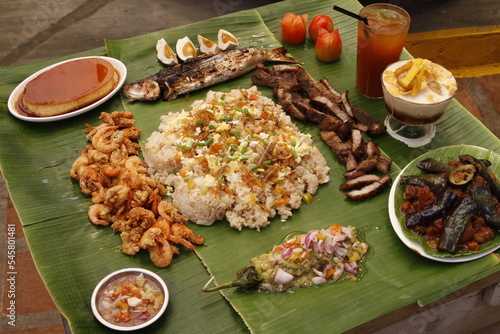 Budol budol fight food: hipon, isda, liempo, talong, leche flan, halo-halo, fried rice - local and traditional Filipino dishes photo