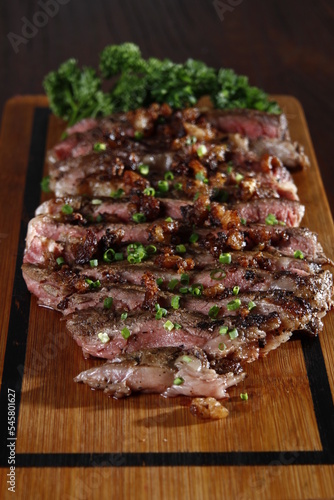 Chopped rib-eye steak on a wooden board