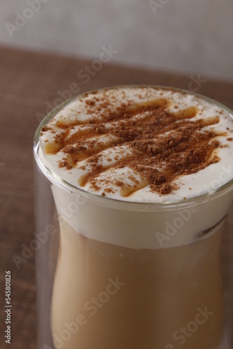 Caramel cappuccino with frothed milk sprinkled with chocolate