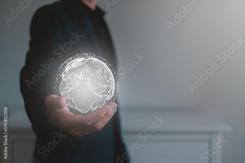the concept of technology internet network. a man holding a virtual globe on hand show global network. 