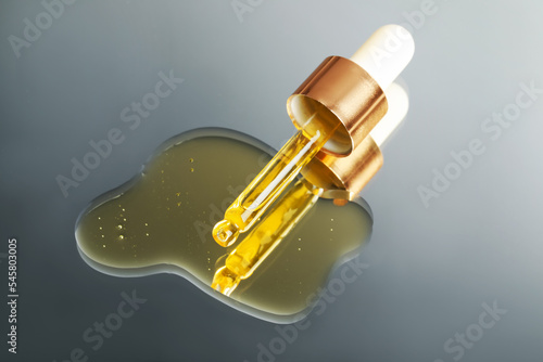 Yellow serum with pipette on mirror, closeup