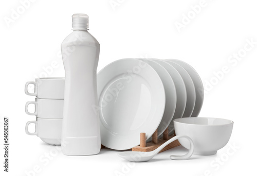 Clean dishware and bottle of detergent isolated on white