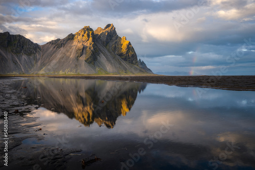 Vestrahorn mountain at dusk and its reflection on the black sand beach, Iceland © David