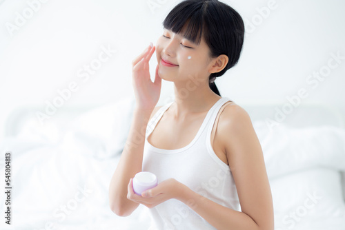 Free Download Beautiful young asian woman holding cartridge applying cream or lotion with moisturizer to skin on face, beauty asia girl applying skincare touch facial with cosmetic makeup, skin care concept. - GFXLoad