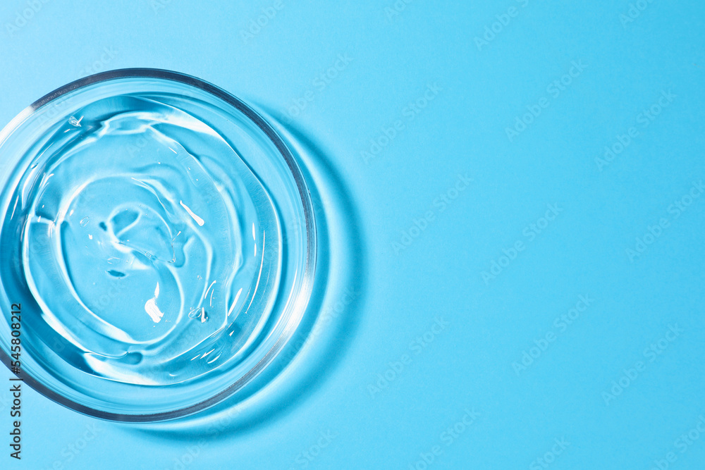Petri dish with liquid on light blue background, top view. Space for text Petri dish with liquid on light blue background, top view. Space for text