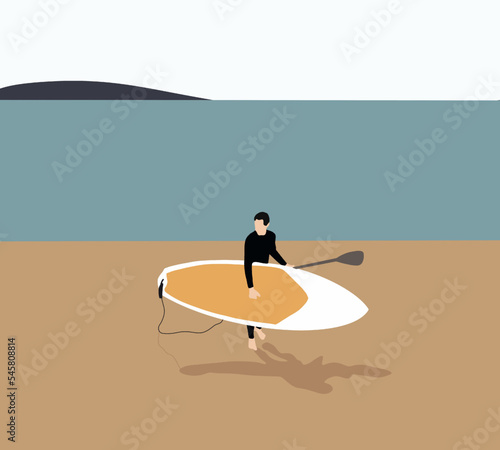Man in black wetsuit holding paddle board walking on the beach. Active recreation.