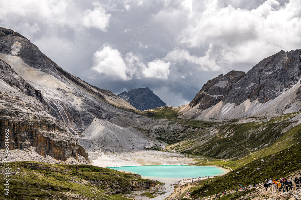 Obraz premium Unrecognizable tourists at beautiful landscapes of Milk Lake in Yading Nature Reserve,The Yading Nature Reserve in the Kham region of Sichuan is one of the most beautiful places on the Tibetan Plateau
