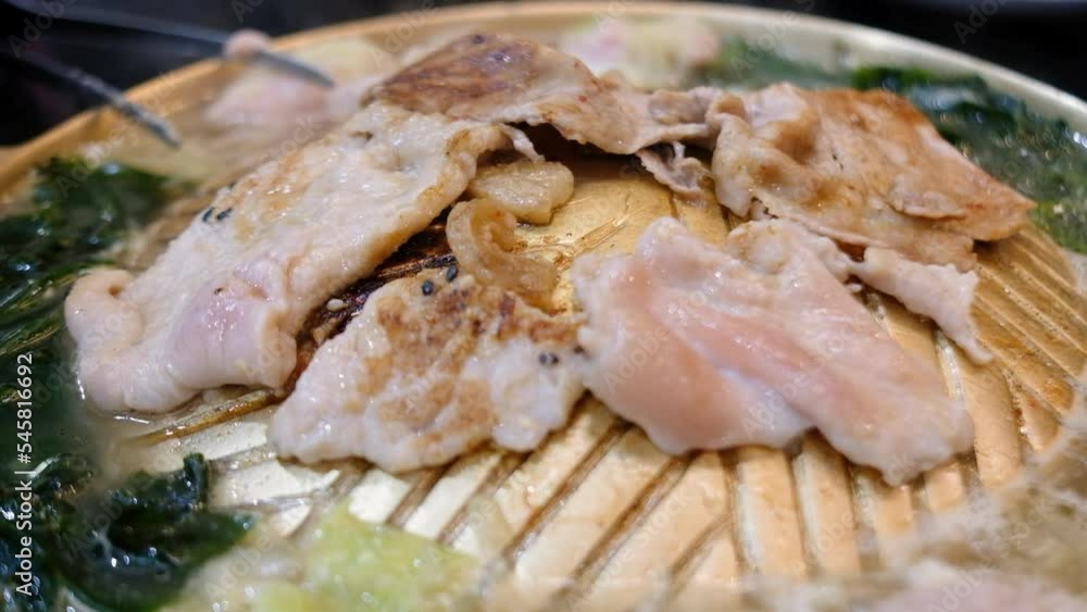 Thai style barbecue or Mookata, raw meat with spicy sauce grilled on the stove, 4K Thai style barbecue or Mookata, raw meat with spicy sauce grilled on the stove, 4K