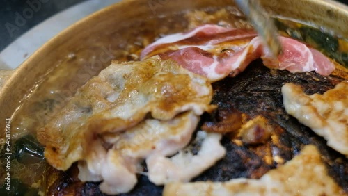 Thai style barbecue or Mookata, raw meat with spicy sauce grilled on the stove, 4K