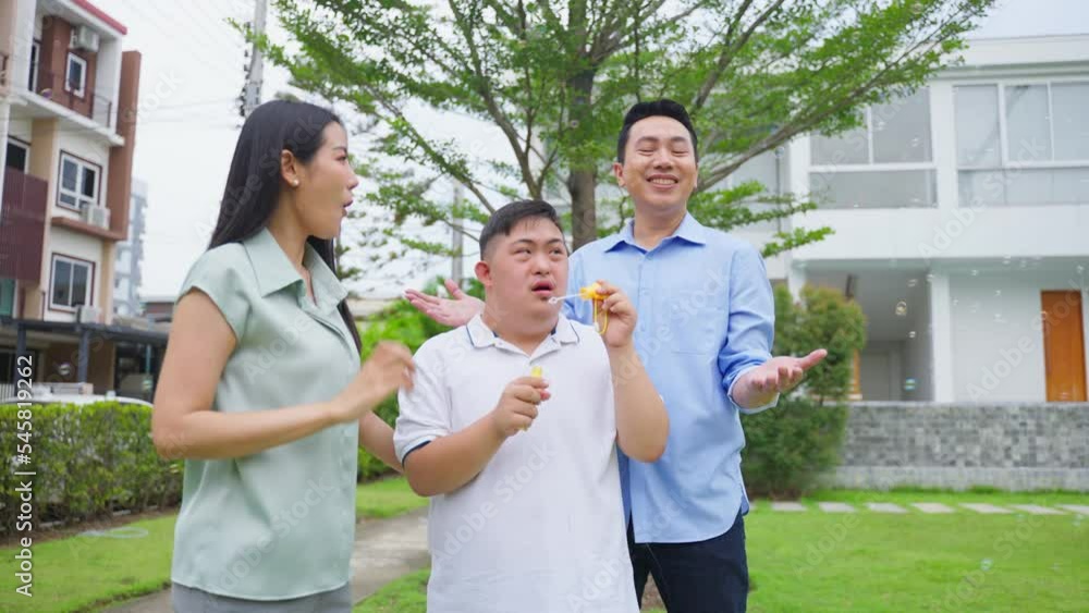 Asian attractive family, parents playing with young son in the garden. Asian attractive family, parents playing with young son in the garden.