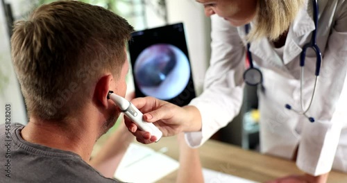 Adult male during ear examination at hearing clinic photo