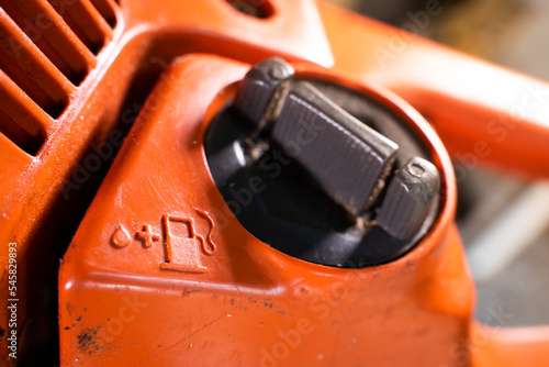 Fotografie Tank for filling the fuel mixture with oil in the chainsaw