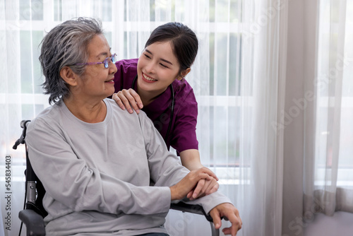 Caregiver nurse take care a Senior patient sit on wheelchair. Nurse helping senior Woman