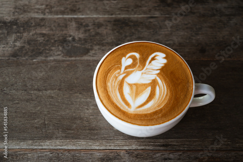 Fototapeta Naklejka Na Ścianę i Meble -  Latte art coffee with swan shape in coffee cup on wooden background, Hot drink
