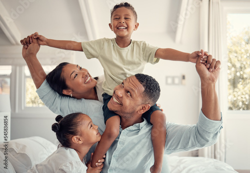 Mother, father and kids, a happy family playing on bed in home, smile and laugh with piggy back on holiday weekend. Love, fun and family time for dad, mom and children in family bedroom in Brazil.