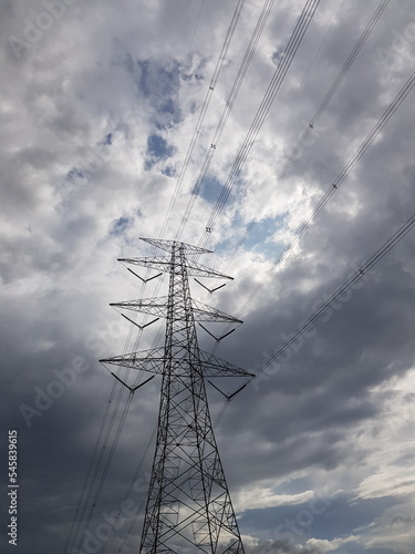 Tower SUTET or extra high voltage airways with a very dark cloudy sky background. © CindhyAde