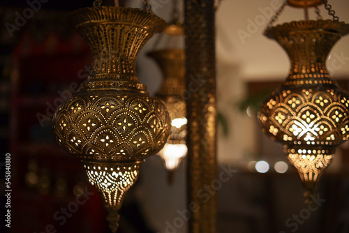 Hanging golden lantern lamp with arabic decoration for muslim background 