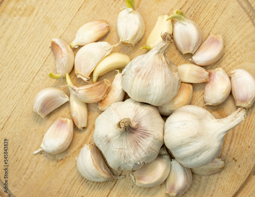 Garlic bulbs and cloves on a wooden cutting board