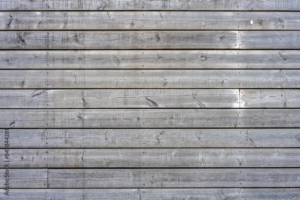 Background from a wall made of gray and worn wooden planks