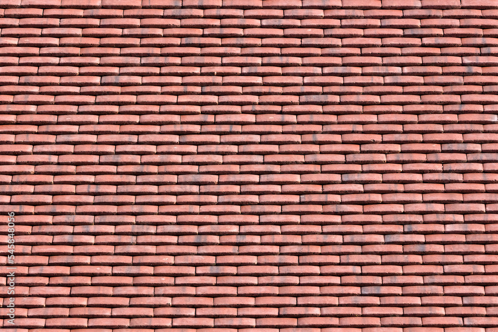 Background texture from image of red clay tiles on new roof Background texture from image of red clay tiles on new roof