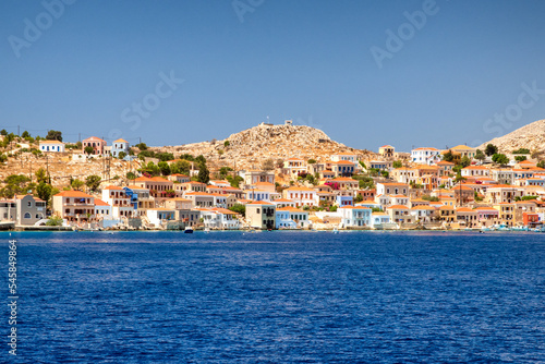 Colorful houses in picturesque small island Halki in Greece