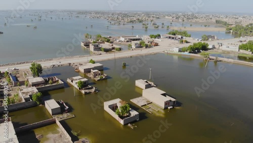 Aerial View Of Floods Surrounding Rural Buildings In Jacobabad, Sindh.  Slow Descending Shot photo
