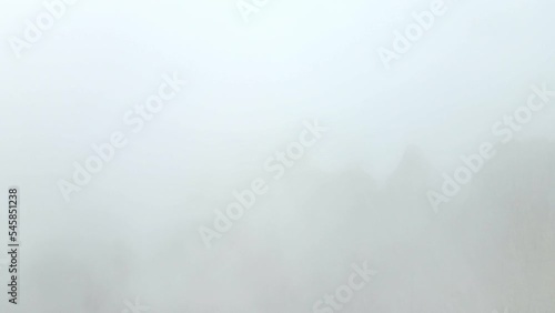 Aerial views of mountain range in the Dolomites, Italy, in a foggy day photo