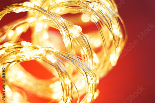 christmas beautifull shiny gold garland on a red background. sparkle festive background