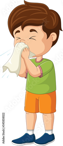 Cute little boy sneezing with blowing nose into tissue paper