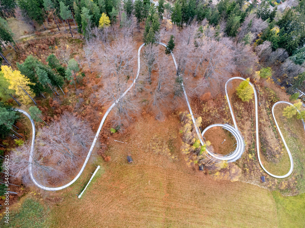 Aerial view of summer bob track in beautiful nature with green mountains in Poland.
