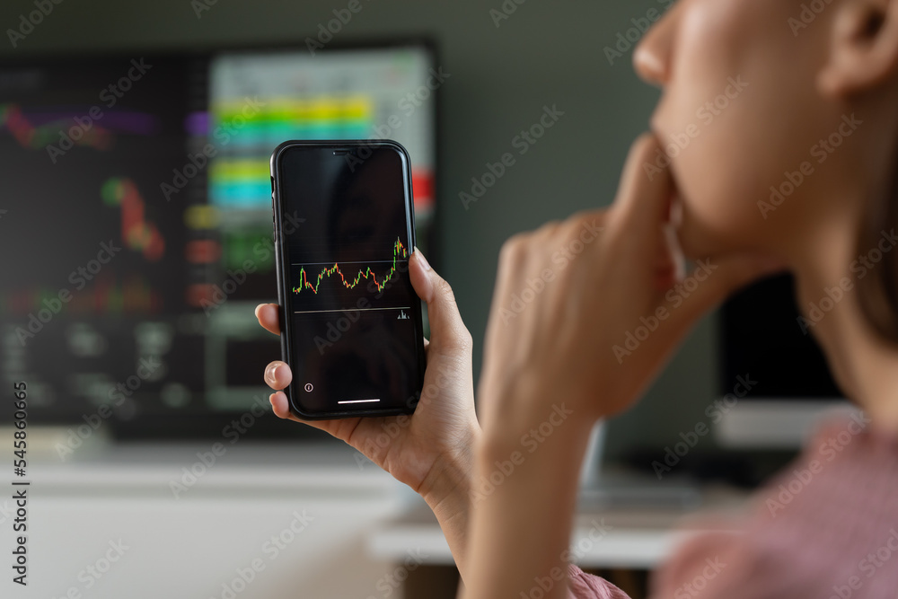 Investor analyzing exchange market, asian young business woman, girl trader on graphic charts on tablet, smartphone for trading stock, looking at screen with diagrams at home office. Start up people.