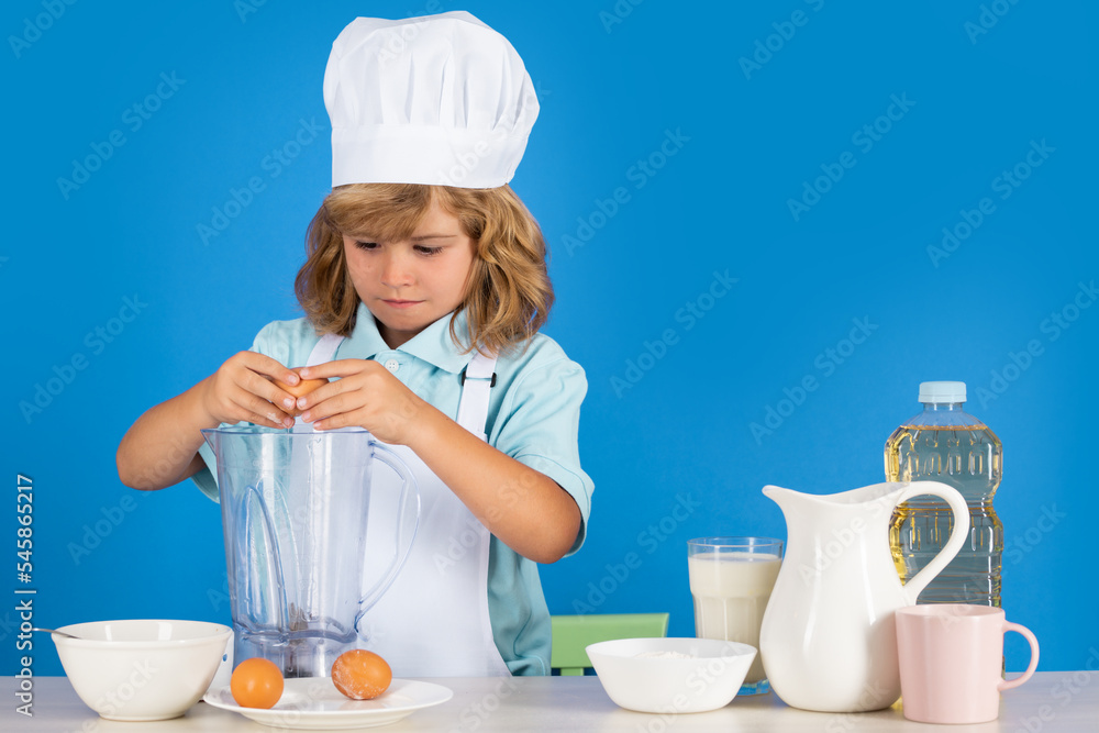 Portrait of chef child in cook hat. Cooking at home, kid boy preparing food from vegetable and fruits. Healthy eating. Portrait of chef child in cook hat. Cooking at home, kid boy preparing food from vegetable and fruits. Healthy eating.