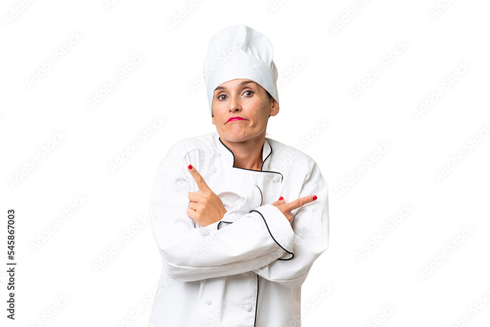 Middle-aged chef woman over isolated background pointing to the laterals having doubts