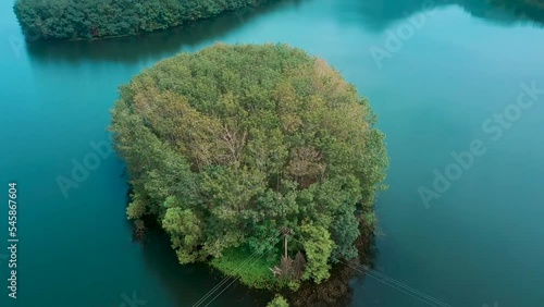 Aerial view. Green island in the middle of the lake. 