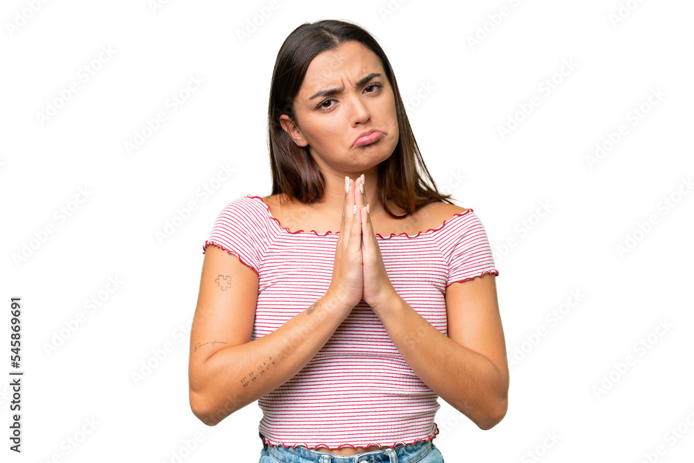 Young caucasian woman isolated on green chroma background keeps palm together. Person asks for something Young caucasian woman isolated on green chroma background keeps palm together. Person asks for something