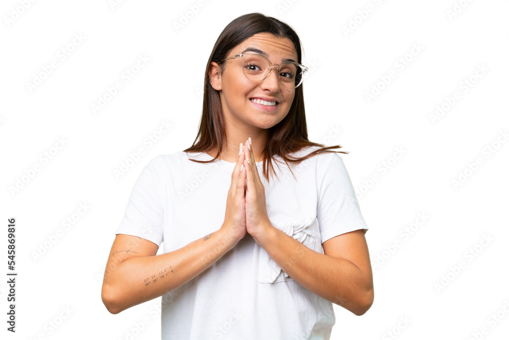 Young caucasian woman isolated on green chroma background keeps palm together. Person asks for something Young caucasian woman isolated on green chroma background keeps palm together. Person asks for something