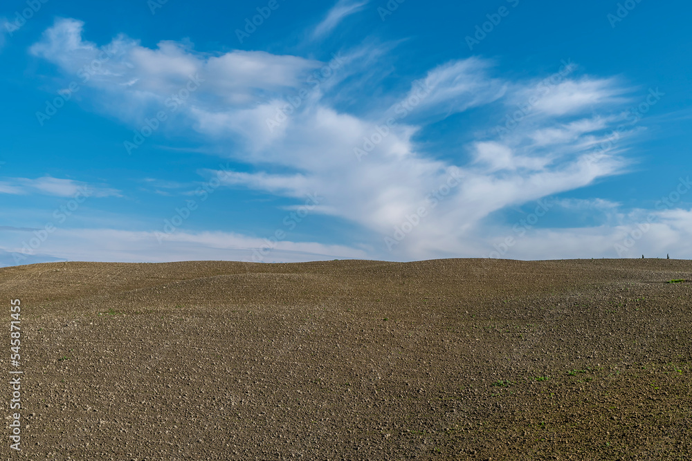 A plowed field against a beautiful sky in the Tuscan countryside during the winter season, Casciana Terme, Pisa, Italy