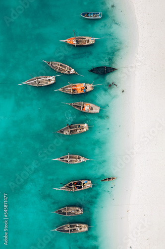 Top view or aerial view of Beautiful crystal clear water and white beach with long tail boats in summer of Zanzibar island