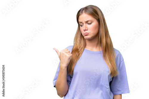 Wallpaper Mural Young beautiful woman over isolated background unhappy and pointing to the side Torontodigital.ca