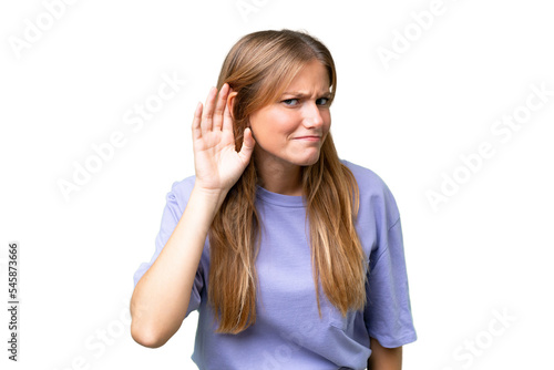 Young beautiful woman over isolated background listening to something by putting hand on the ear
