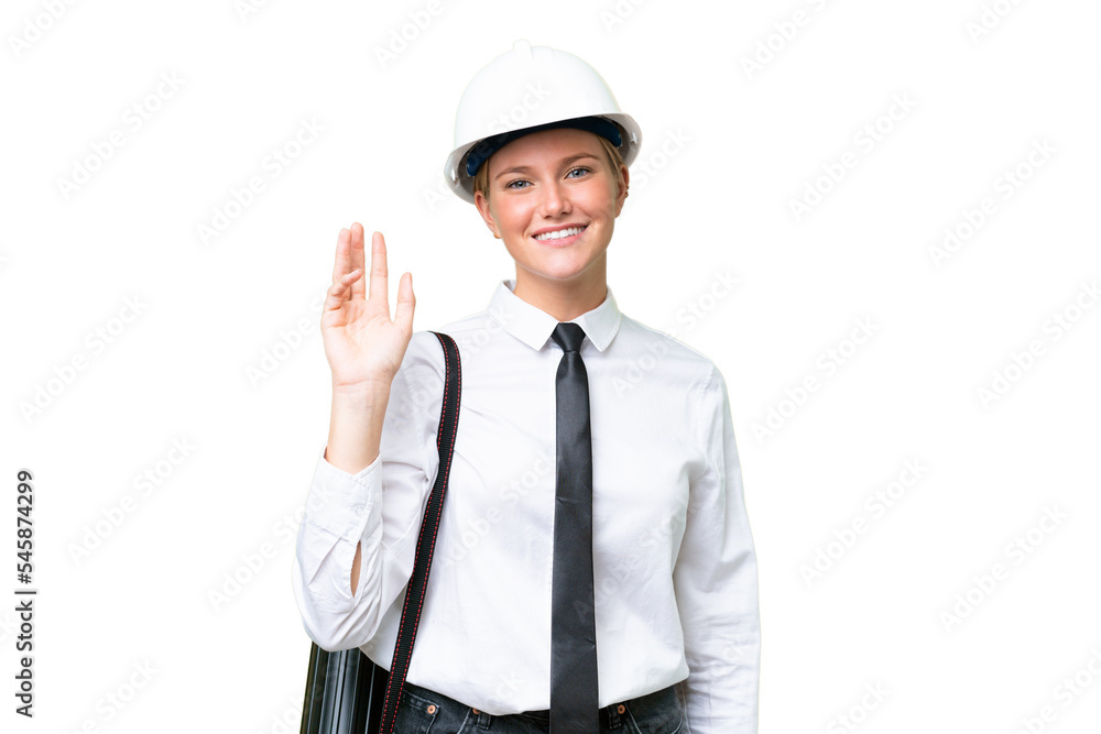 Young architect caucasian woman with helmet and holding blueprints over isolated background saluting with hand with happy expression Young architect caucasian woman with helmet and holding blueprints over isolated background saluting with hand with happy expression