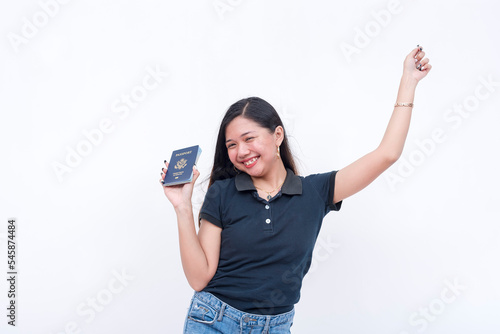 A happy asian woman celebrates after receiving her US passport. Isolated on a white background.