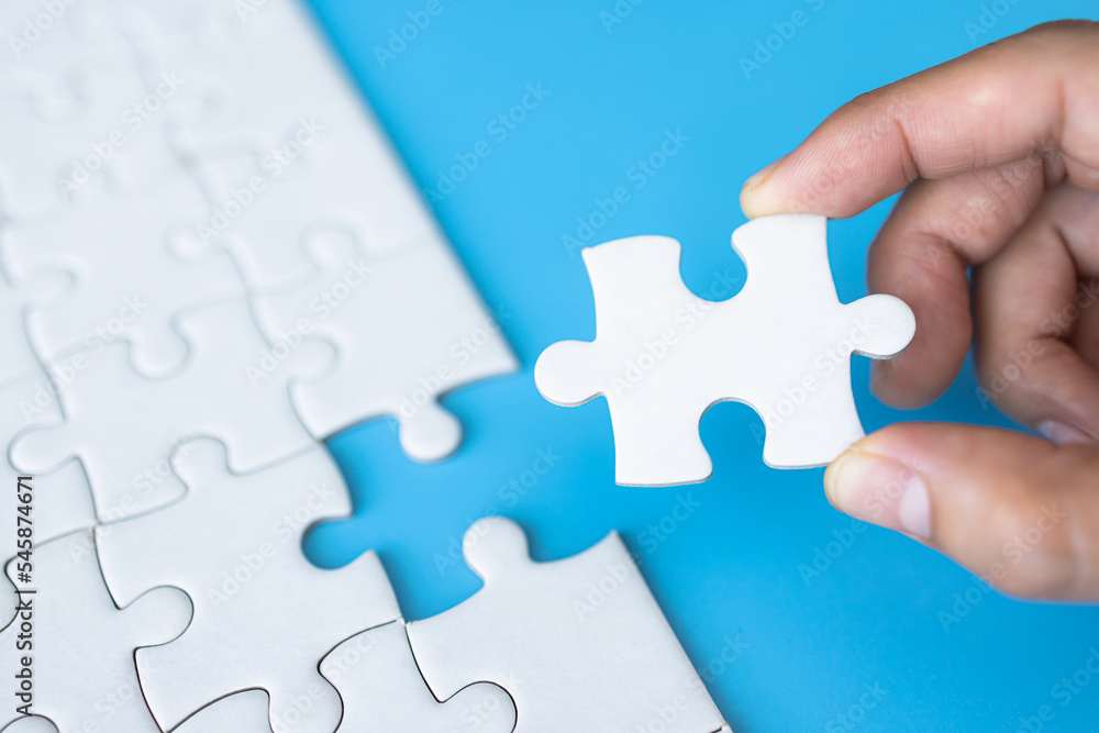 White jigsaw in the hands, The correct solution. Teamwork, Solving and completing the task. Last piece of jigsaw puzzle. Assembling jigsaw puzzle pieces. White jigsaw in the hands, The correct solution. Teamwork, Solving and completing the task. Last piece of jigsaw puzzle. Assembling jigsaw puzzle pieces.