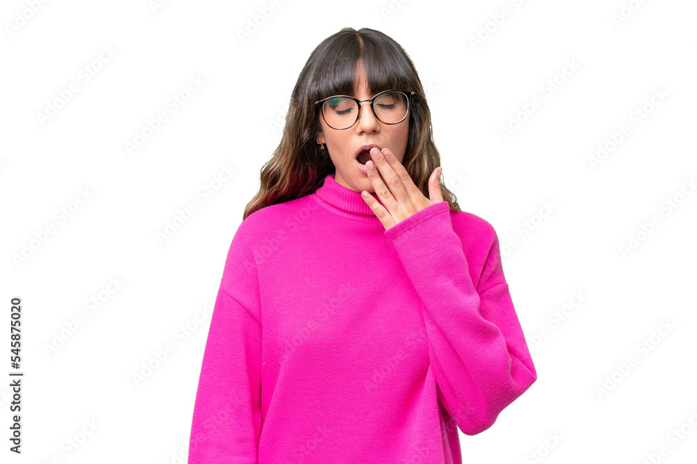 Young caucasian woman over isolated background yawning and covering wide open mouth with hand Young caucasian woman over isolated background yawning and covering wide open mouth with hand
