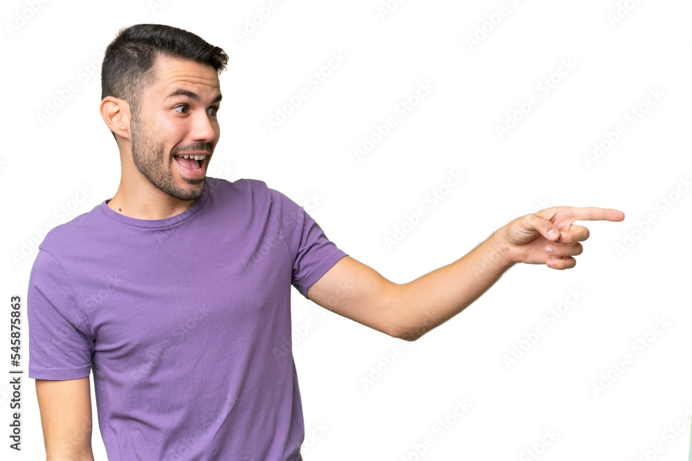 Young handsome caucasian man over isolated background pointing finger to the side and presenting a product Young handsome caucasian man over isolated background pointing finger to the side and presenting a product