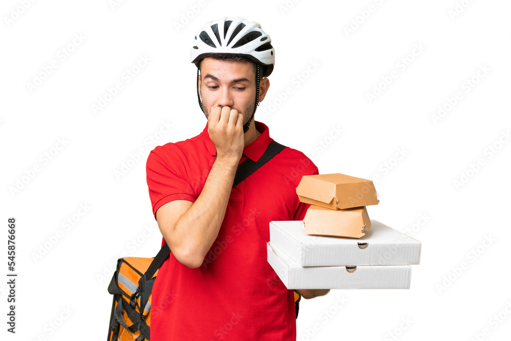 Young handsome caucasian man with thermal backpack and holding takeaway food over isolated background having doubts Young handsome caucasian man with thermal backpack and holding takeaway food over isolated background having doubts