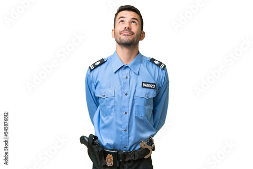 Young police caucasian man over isolated background and looking up