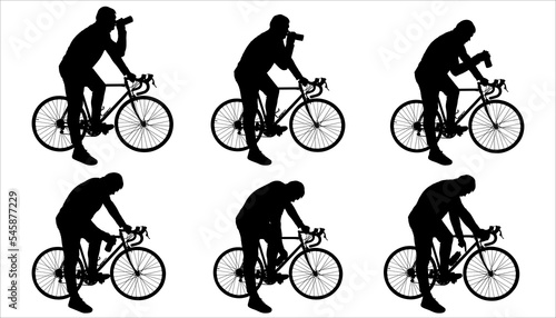 The cyclist holds a bottle of water in his hand. A guy thirsty for water on a bicycle drinks water from a bottle. A man stands next to a bicycle. View: bike, man - sideways. The guy with the bike.