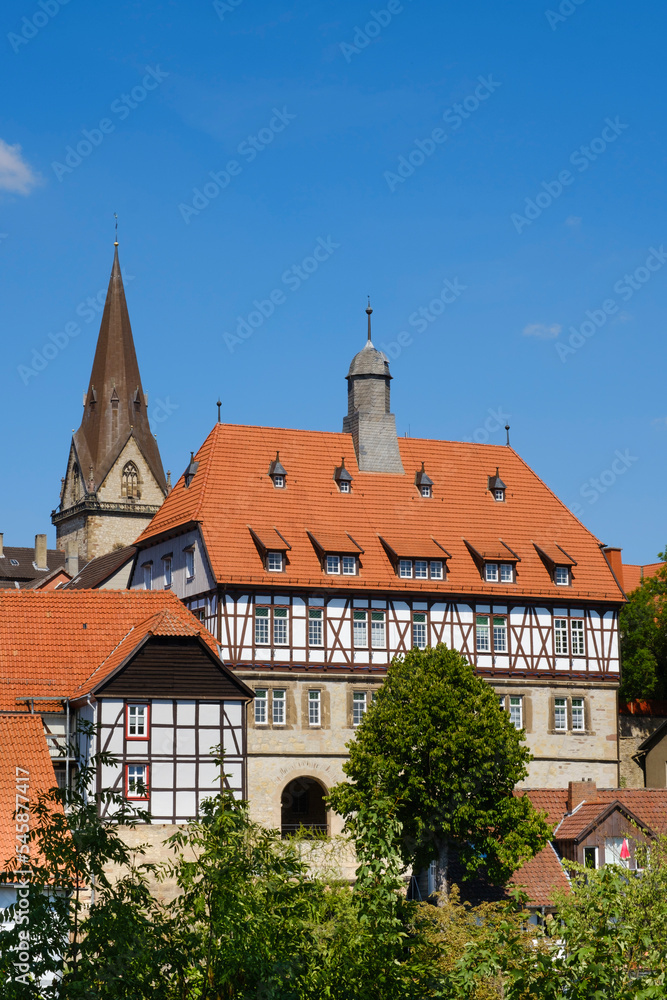 Germany, North Rhine-Westphalia, Warburg, Half-timbered town hall with church bell tower in background Germany, North Rhine-Westphalia, Warburg, Half-timbered town hall with church bell tower in background