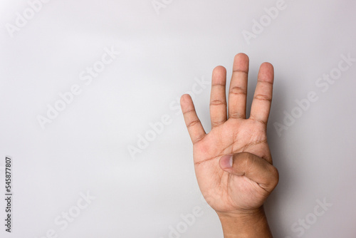man hand number four gesture. number 4 hand sign isolated on white. pointing the finger © fery